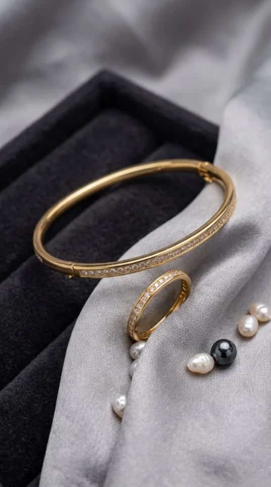 Gold pavé crystal bangle and ring set with continuous stone line on fabric