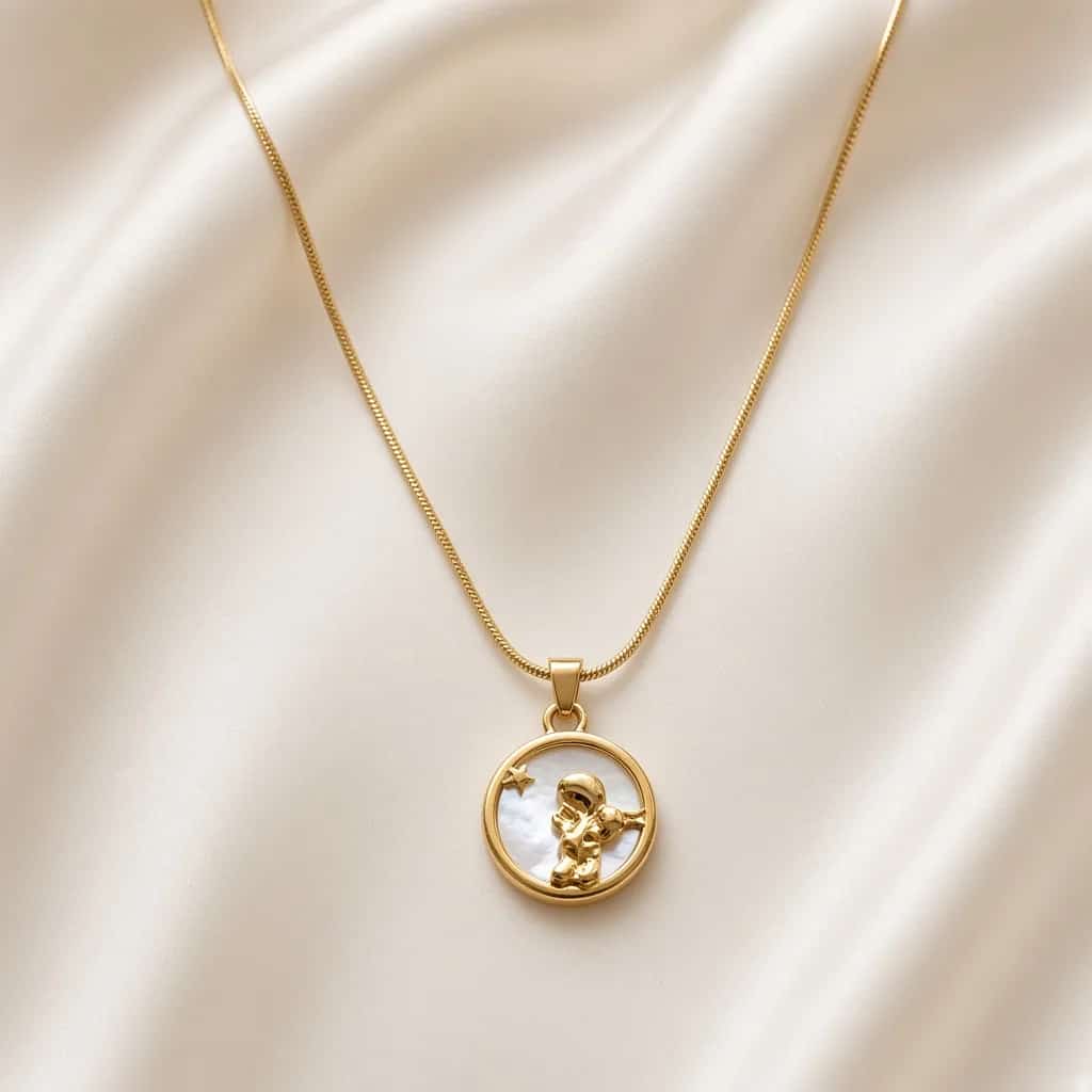 Gold necklace with a round coin-style engraved pendant on a fine chain