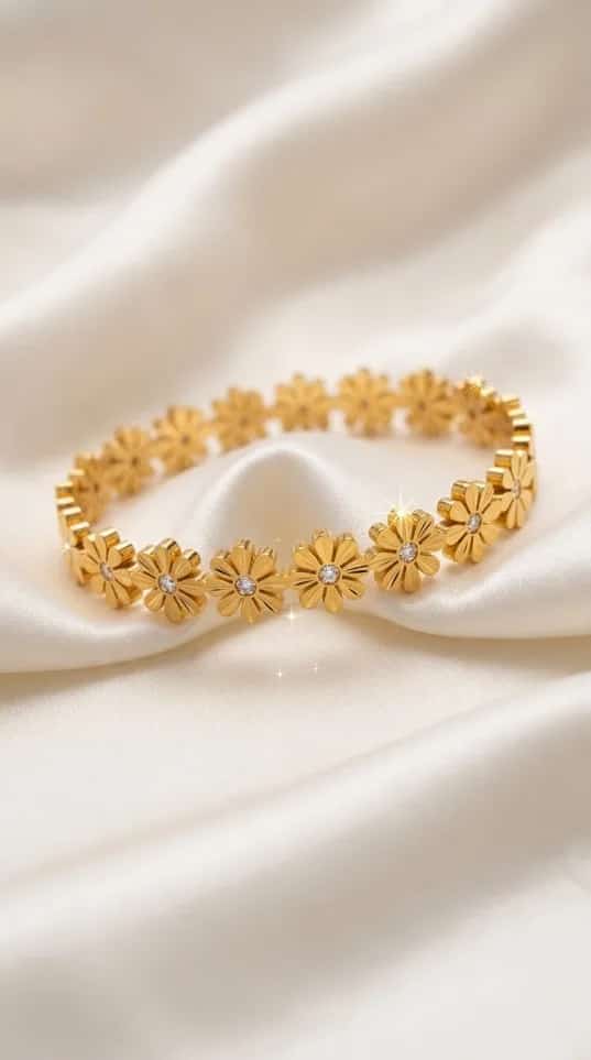 Gold daisy flower link bracelet with crystal centers on satin fabric